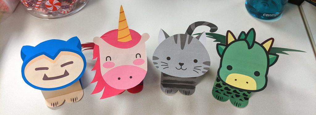 four animal bobbleheads made of paper (snorlax-inspired, unicorn, cat, dragon)
